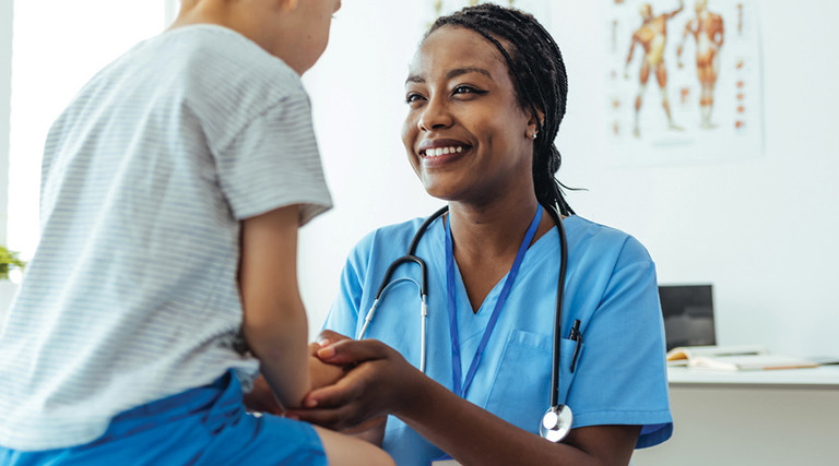 Doctor consoling young patient 